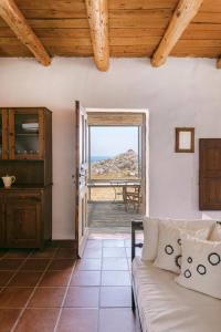 a living room with a couch and a view of the ocean at Villa Unica in Yiannioú