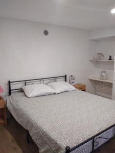 a bedroom with a bed with white pillows at LANZO IN CORTE APPARTAMENTO in Lanzo dʼIntelvi