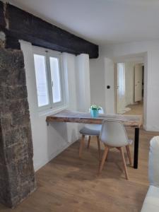 a dining room with a table and a chair at LANZO IN CORTE APPARTAMENTO in Lanzo dʼIntelvi