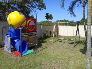 a playground in a yard with a swing at Heberden chalets in Melville