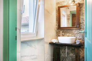 a bathroom with a sink and a mirror at La Tua Dimora tra le Cinque Terre e le Alpi Apuane in Sarzana +77 photos