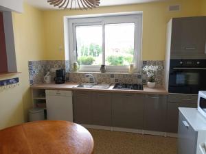 a kitchen with a sink and a window at Chez Tartine in Thénioux