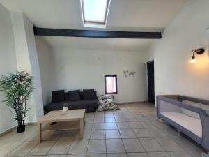 a living room with a couch and a table at Le Rempart in Saint-Mitre-les-Remparts