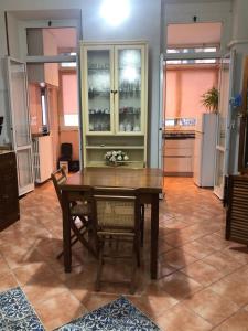 a dining room with a table and chairs and a kitchen at Maison Angelo - citra 8055LT2291 in Sanremo