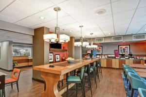 a large dining room with a long table and chairs at Hampton Inn Charlotte-Gastonia in Gastonia