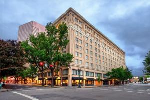 a large building on the corner of a street at Embassy Suites by Hilton Portland Downtown in Portland