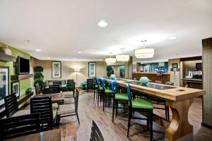 a dining room with a long table and chairs at Hampton Inn by Hilton Milford in Milford