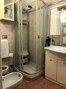 a bathroom with a shower and a toilet and a sink at Maison Angelo - citra 8055LT2291 in Sanremo +11 photos
