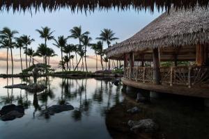 a resort with palm trees and a body of water at Ho'olei at Grand Wailea in Wailea