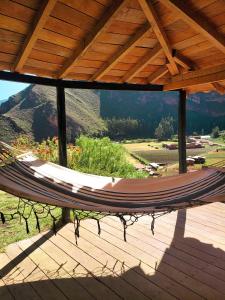 eine Hängematte auf einer Terrasse mit Bergblick in der Unterkunft Wolf Totem Backpacker Steam Punk Villa in Pisac