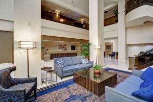 a lobby with blue couches and a coffee table at Embassy Suites by Hilton Santa Clara Silicon Valley in Santa Clara