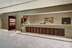 a lobby of a store with a counter and a store at Embassy Suites by Hilton Santa Clara Silicon Valley in Santa Clara