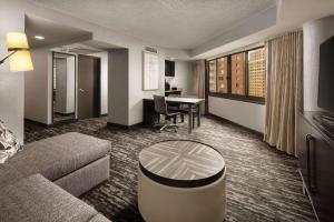 a living room with a couch and a table at Embassy Suites by Hilton Crystal City National Airport in Arlington