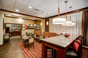 a dining room and living room with a table and chairs at Hampton Inn Baltimore/Glen Burnie in Glen Burnie