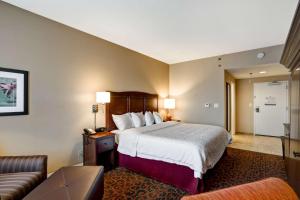 a hotel room with a bed and a couch at Hampton Inn Baltimore/Glen Burnie in Glen Burnie
