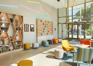 a lobby with colorful chairs and tables and shelves at Hampton By Hilton Dublin City Centre in Dublin