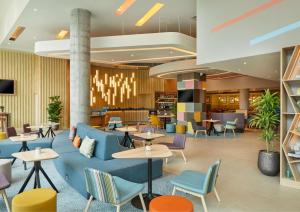 a lobby of a hotel with tables and chairs at Hampton By Hilton Dublin City Centre in Dublin