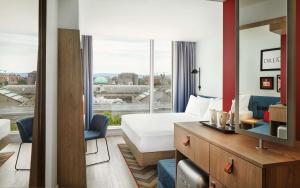 a hotel room with a bed and a large window at Hampton By Hilton Dublin City Centre in Dublin