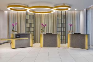 a lobby with two reception desks and purple flowers at Hilton Dublin Kilmainham in Dublin