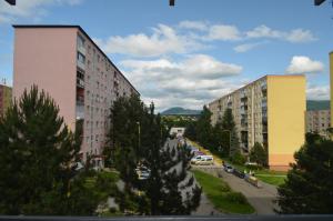 a group of buildings with cars parked in a parking lot at Apartment Hemsen in Prešov
