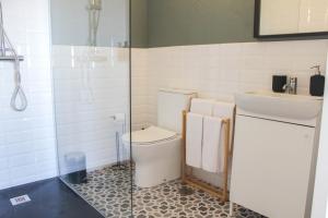a bathroom with a toilet and a sink at Refúgio das Carquejas in Mondim de Basto