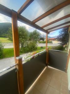 eine abgeschirmte Veranda mit Gartenblick in der Unterkunft Haus Bergfriede 2 in Obsteig