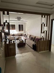 a living room with a couch and a table at Appartement de Lux Hay Al MATAR in Nador