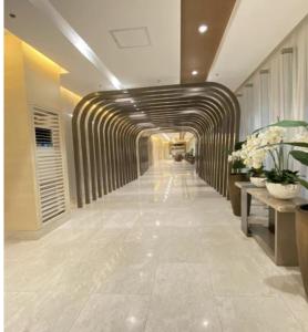 a hallway in a building with a hallwayngth at MOA Pasay, Shore 3 Residences - Modern Luxury Condo in Manila