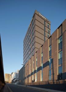 a building with a sign on the side of it at Hampton By Hilton Leeds City Centre in Leeds