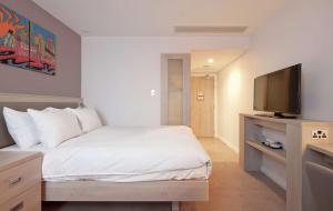 a bedroom with a bed and a flat screen tv at Hampton By Hilton Leeds City Centre in Leeds