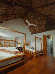 a bedroom with two bunk beds and a ceiling at Praba Hostel in Palomino