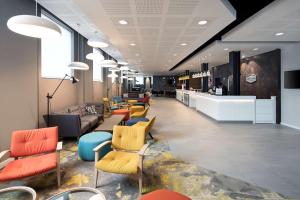 a lobby with colorful chairs and a waiting room at Hampton By Hilton London Docklands in London