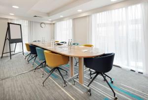 a conference room with a long table and chairs at Hampton By Hilton London Docklands in London