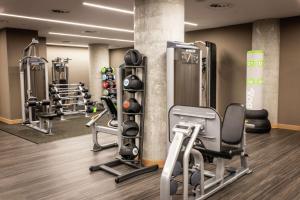a gym with several treadmills and weights at Lincoln Plaza Hotel London, Curio Collection By Hilton in London