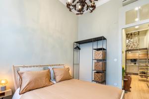 a bedroom with a bed and a chandelier at Sé Apartamentos - Miau Apartment in Braga