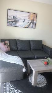a living room with a couch and a coffee table at Menlyn Place Staycation in Pretoria
