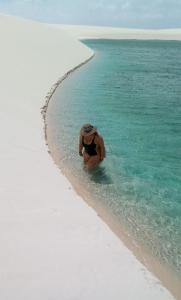 a person in the water on a beach at Rancho Dias in Atins