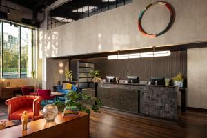 a lobby with a counter and a table and chairs at The Gantry London, Curio Collection By Hilton in London