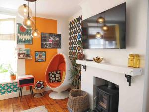 a living room with a fireplace and a tv at Revival Retreat, with parking in Whitstable