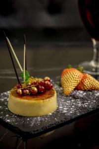 a dessert with grapes and fruit on a table at Doubletree By Hilton London - Greenwich in London