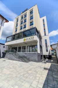 a building with a dukkrit sign on it at Hotel DUKAT in Gura Humorului