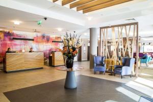 a lobby with a vase of flowers on a table at DoubleTree by Hilton London Angel Kings Cross in London