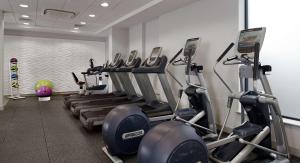 a gym with a row of treadmills and machines at DoubleTree by Hilton London Angel Kings Cross in London