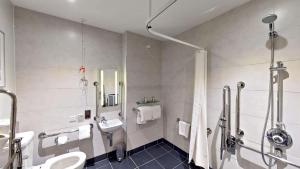 a bathroom with a toilet and a sink and a shower at DoubleTree by Hilton London Angel Kings Cross in London
