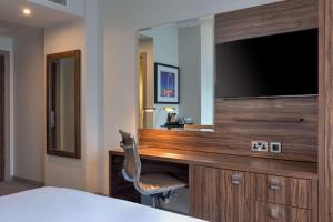 a hotel room with a desk and a television at DoubleTree by Hilton London Angel Kings Cross in London