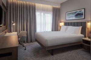 a hotel room with a white bed and a window at DoubleTree by Hilton London Angel Kings Cross in London