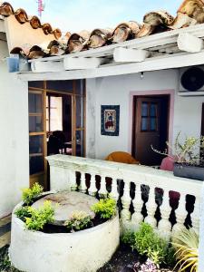 ein Haus mit einer Veranda und einer Treppe mit Pflanzen in der Unterkunft Casa La Escondida Tlacotalpan in Tlacotalpan