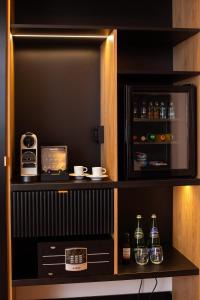 a drink cabinet with two bottles of alcohol at HOTEL TEATR in Krakow