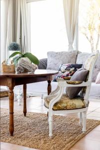 a living room with a table and a couch at Le Cœur du Breuil in Segonzac +20 photos