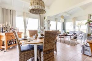 a dining room and living room with a table and chairs at Le Cœur du Breuil in Segonzac